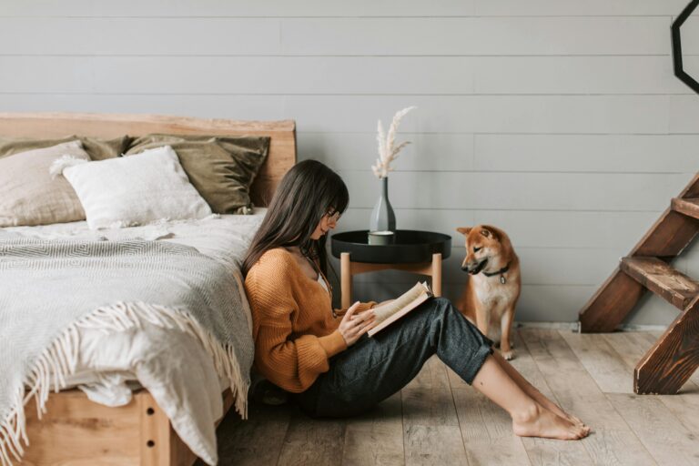 Simplify. Woman in minimal home reading.